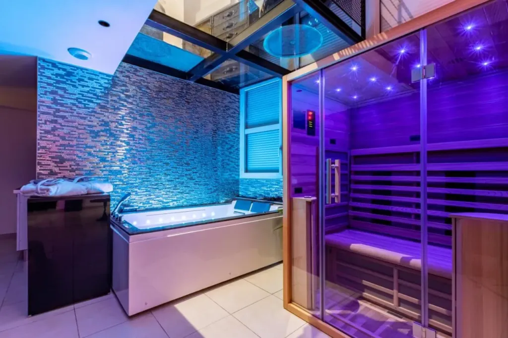 Glamappart'Spa New-York : jacuzzi devant le mur de pierre, love room à Reims
